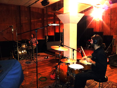 Two drummers drumming in the recording studio